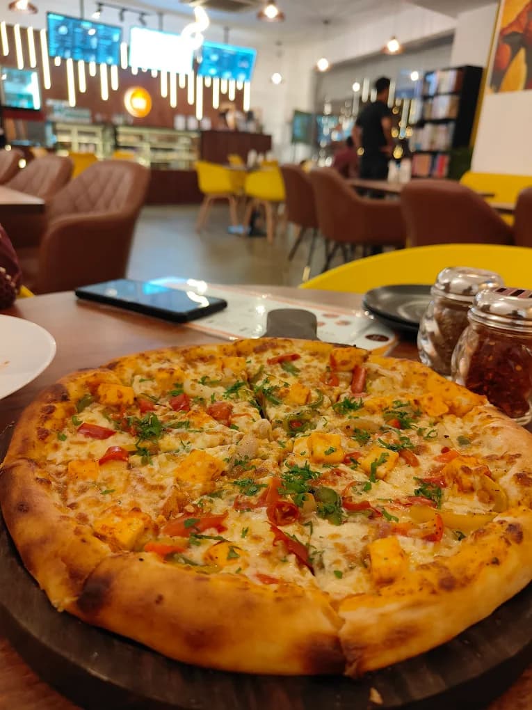 Paneer tikka pizza fresh from the oven at Miravo House